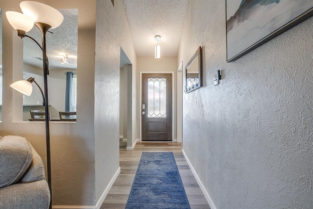 7312 Strawberry Way Fort Worth, TX 76137 - Photo 6 of 40 a view of a hallway with wooden floor and staircase