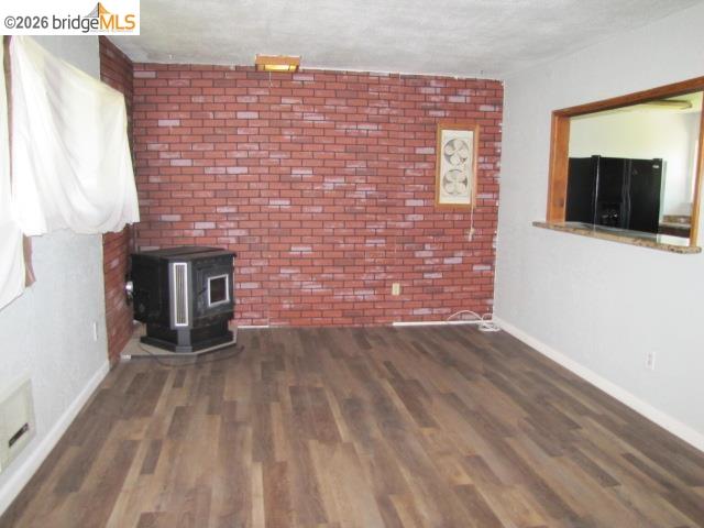 1943 South Ranchero Road Valley Springs, CA 95252 - Photo 11 of 21 a view of an empty room with wooden floor and a fireplace