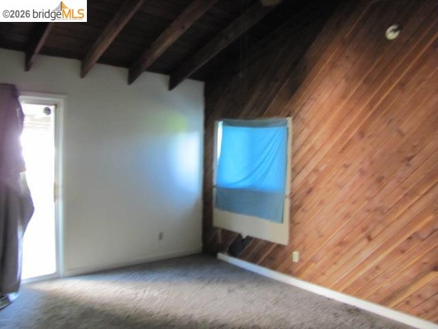 1943 South Ranchero Road Valley Springs, CA 95252 - Photo 13 of 21 Empty room featuring lofted ceiling with beams, carpet, and wood ceiling