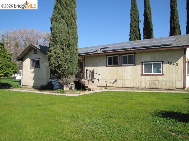 1943 South Ranchero Road Valley Springs, CA 95252 - Photo 6 of 21 View of front of home with solar panels and a front yard