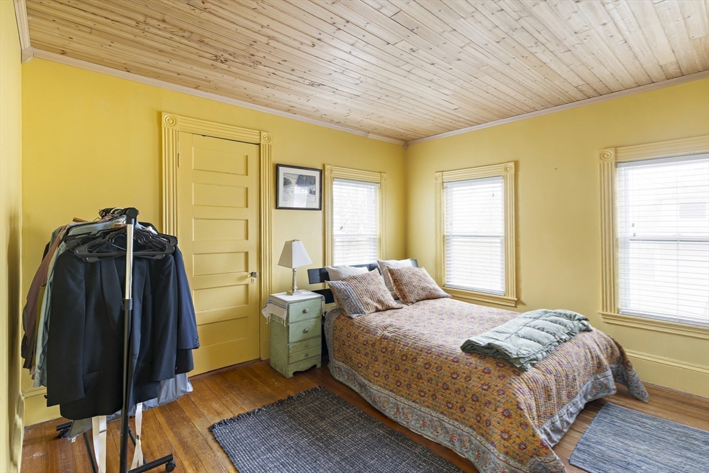 52 Hillside Road Watertown, MA 02472 - Photo 19 of 27 a bedroom with a bed and wooden floor