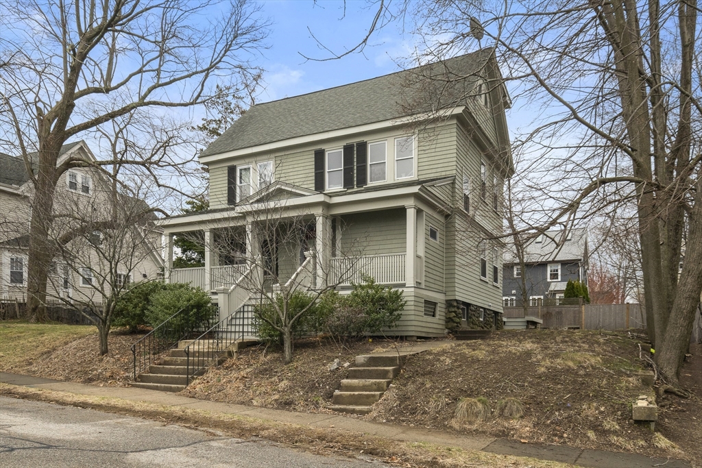 52 Hillside Road Watertown, MA 02472 - Photo 2 of 27 a view of a white house with a large tree