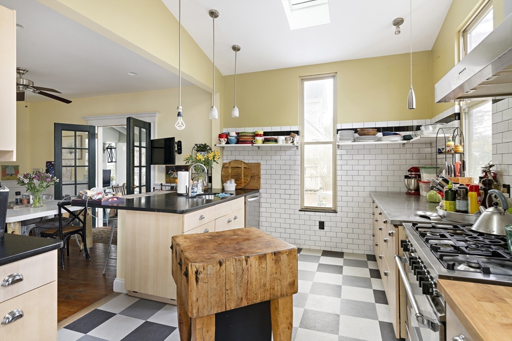 52 Hillside Road Watertown, MA 02472 - Photo 6 of 27 a kitchen with stainless steel appliances kitchen island granite countertop a stove and a cabinets