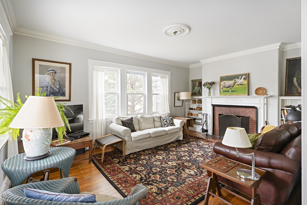 52 Hillside Road Watertown, MA 02472 - Photo 7 of 27 a living room with furniture a fireplace and a large window