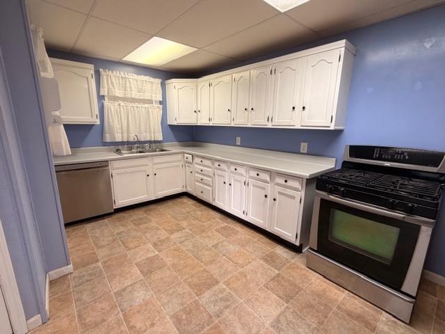 7422 Greenstone Street Houston, TX 77087 - Photo 4 of 15 a kitchen with stainless steel appliances granite countertop a stove a sink and a microwave