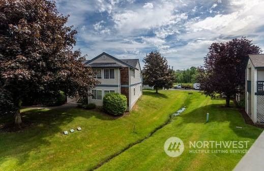 a view of an house with backyard space and garden