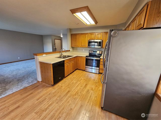 a kitchen with stainless steel appliances granite countertop a stove and a refrigerator
