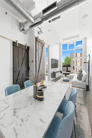 a view of living room kitchen and patio
