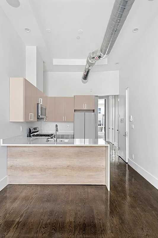 1137 Jefferson Avenue, Unit 3A Brooklyn, NY 11221 - Photo 2 of 10 a view of a kitchen with wooden floor and a sink