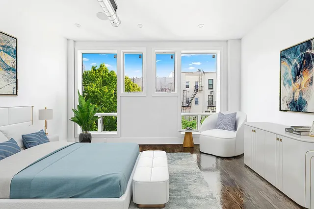 a bedroom with a bed and a potted plant