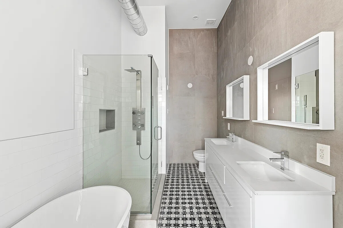 1137 Jefferson Avenue, Unit 3A Brooklyn, NY 11221 - Photo 6 of 10 a bathroom with a sink a toilet a mirror and shower