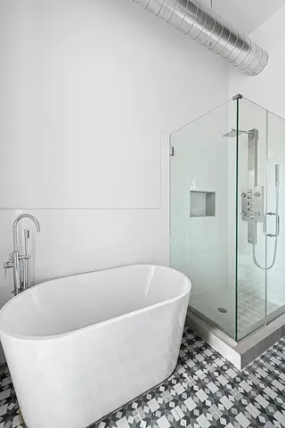 a bathroom with a sink a toilet a mirror and shower