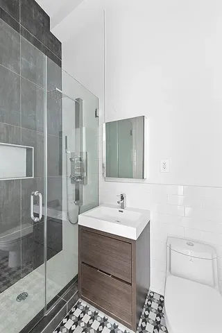 a white bath tub sitting next to a shower