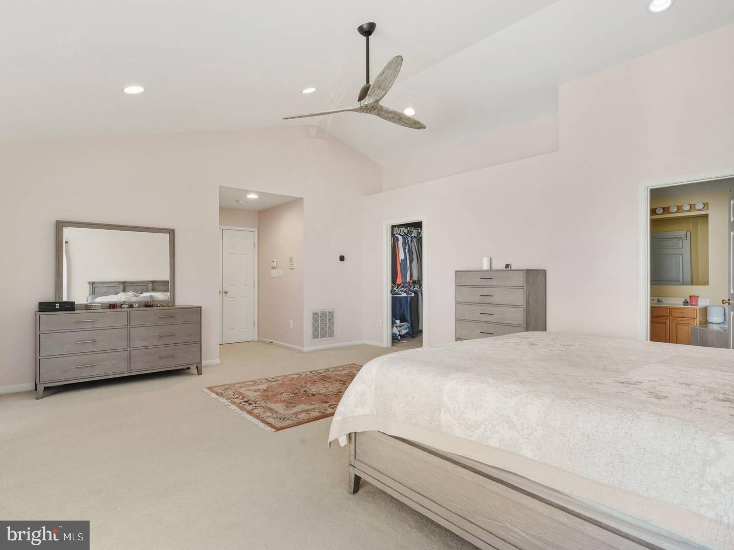 14301 Autumn Crest Road Boyds, MD 20841 - Photo 16 of 40 a spacious bedroom with a bed and a large mirror