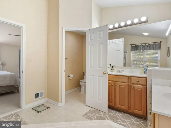 a spacious bathroom with a shower sink and mirror