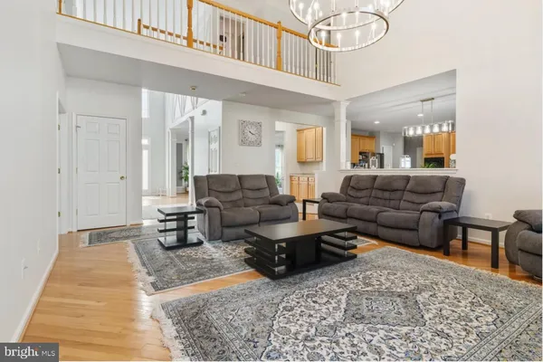 a living room with furniture a rug and a chandelier