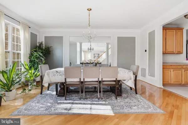 a dining room with furniture a rug and a chandelier