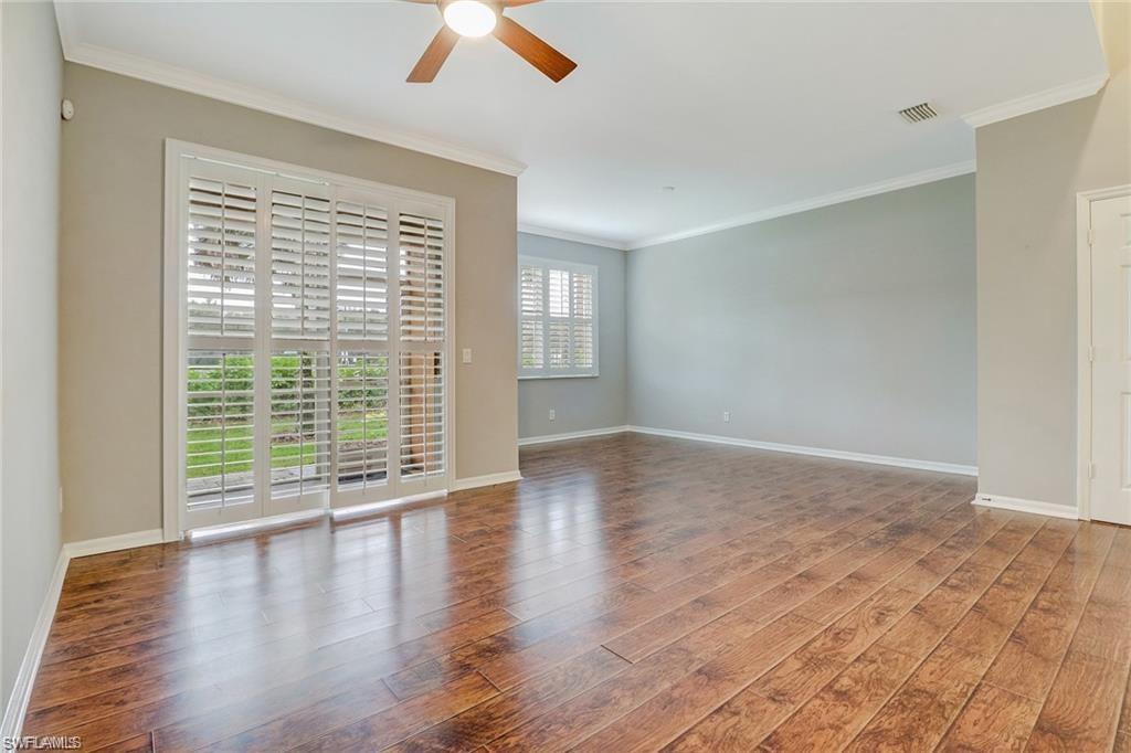 9801 Foxhall Way, Unit 4 Estero, FL 33928 - Photo 5 of 23 Unfurnished room with ornamental molding, wood finished floors, and a ceiling fan