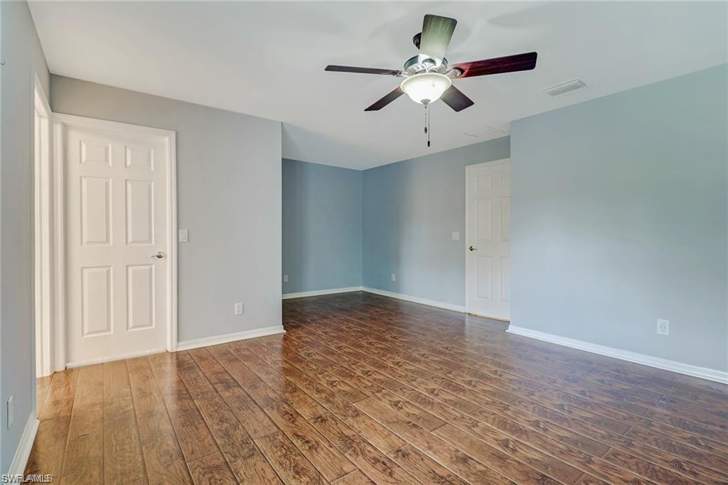 9801 Foxhall Way, Unit 4 Estero, FL 33928 - Photo 9 of 23 Spare room featuring dark wood-type flooring and ceiling fan