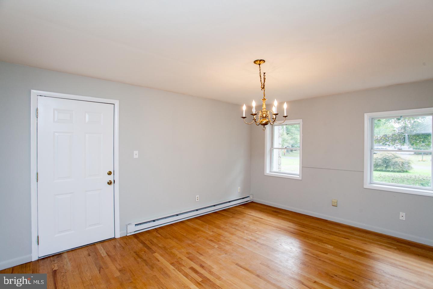 518 Upper Stump Road Chalfont, PA 18914 - Photo 24 of 62 an empty room with wooden floor chandelier and windows