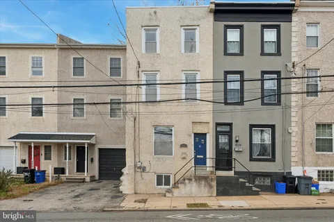 front view of a brick house with a yard