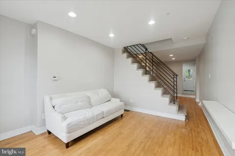 a living room with furniture and stairs