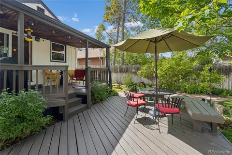 a balcony with wooden floor outdoor seating and wooden floor