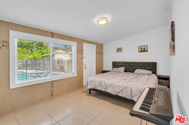 a spacious bedroom with a bed and a window