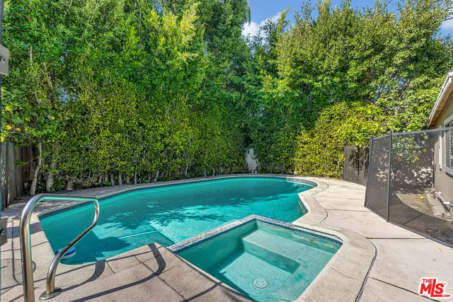 a view of a two chairs in a backyard