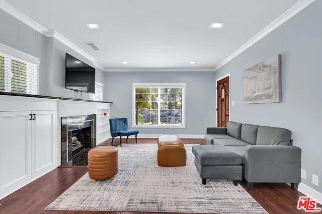 a living room with furniture fireplace and window