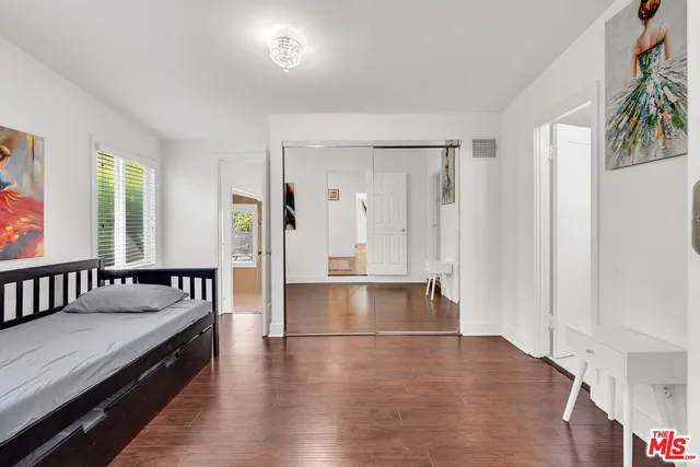 a spacious bedroom with a bed and a table