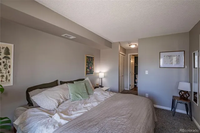 a bedroom with a large bed and a large window