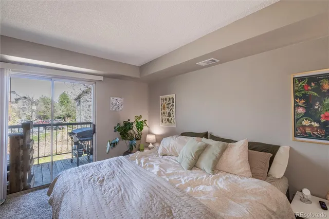 a bedroom with a bed window and a flat screen tv