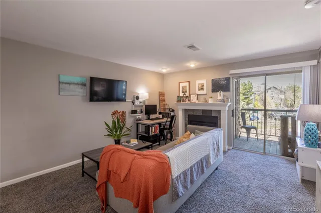 a room with furniture a flat screen tv and a window