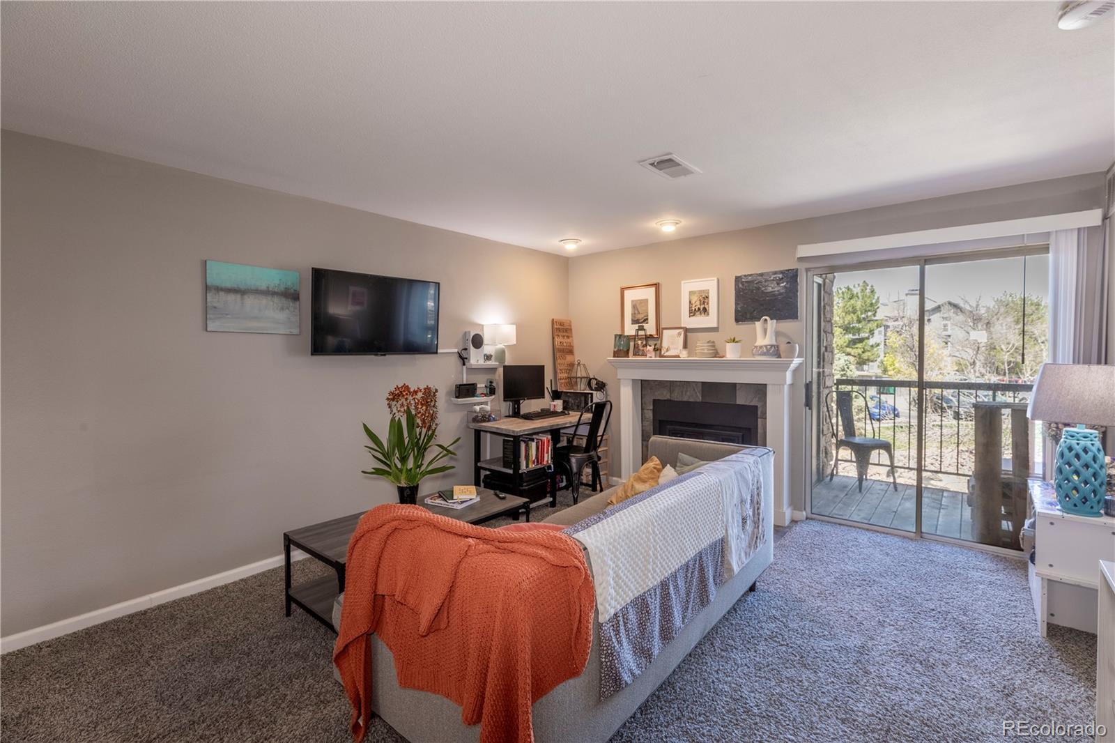 2575 South Syracuse Way, Unit M206 Denver, CO 80231 - Photo 8 of 24 a living room with furniture and a flat screen tv