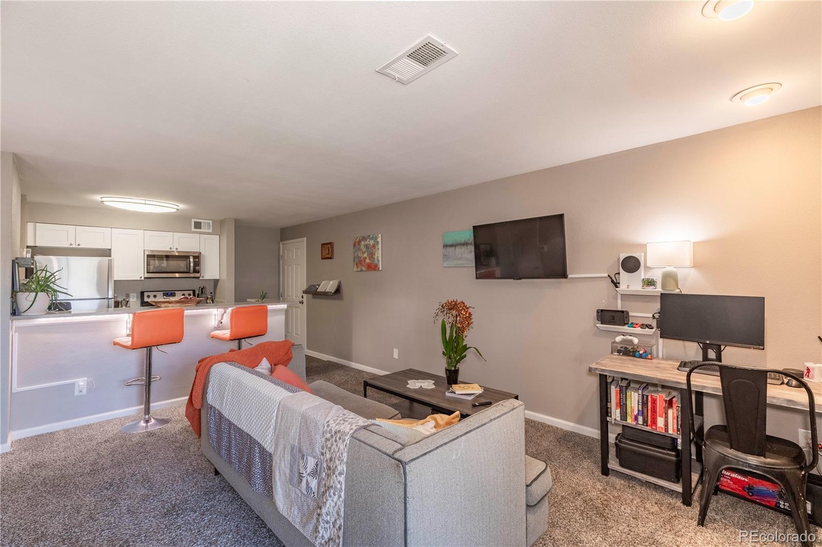 2575 South Syracuse Way, Unit M206 Denver, CO 80231 - Photo 9 of 24 a room with furniture a flat screen tv and a window