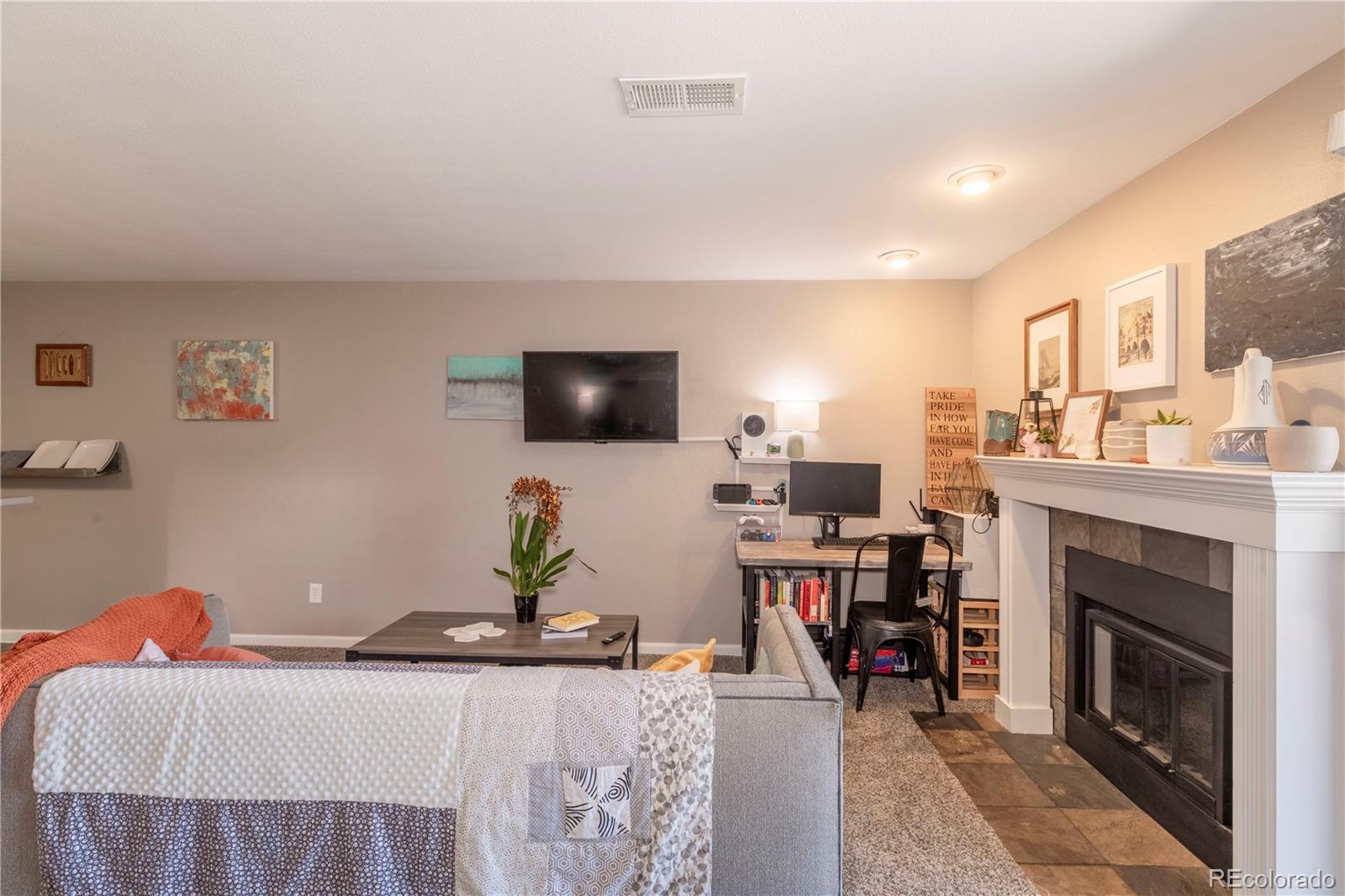 2575 South Syracuse Way, Unit M206 Denver, CO 80231 - Photo 10 of 24 a living room with furniture and a fireplace