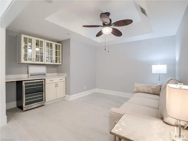 a living room with furniture and ceiling fan