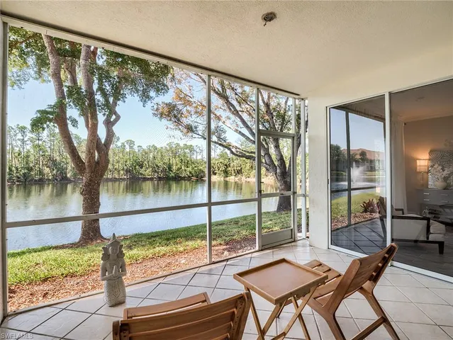 a view of a porch with furniture and a yard