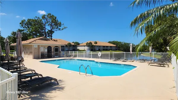 a view of a house with swimming pool and sitting area
