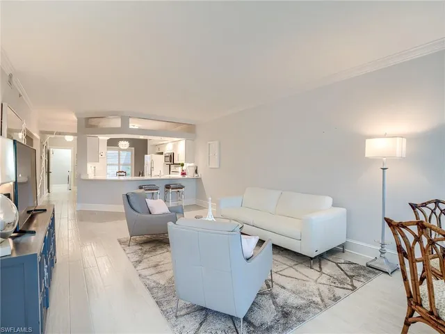 a living room with furniture and a lamp