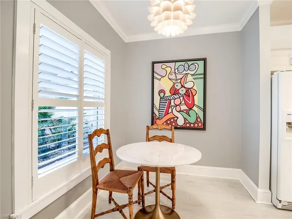 a view of a dining room with furniture a rug and wooden floor