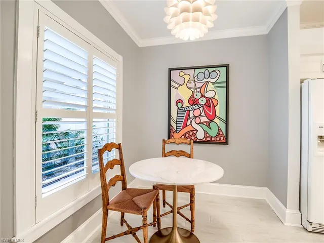 a view of a dining room with furniture a rug and wooden floor