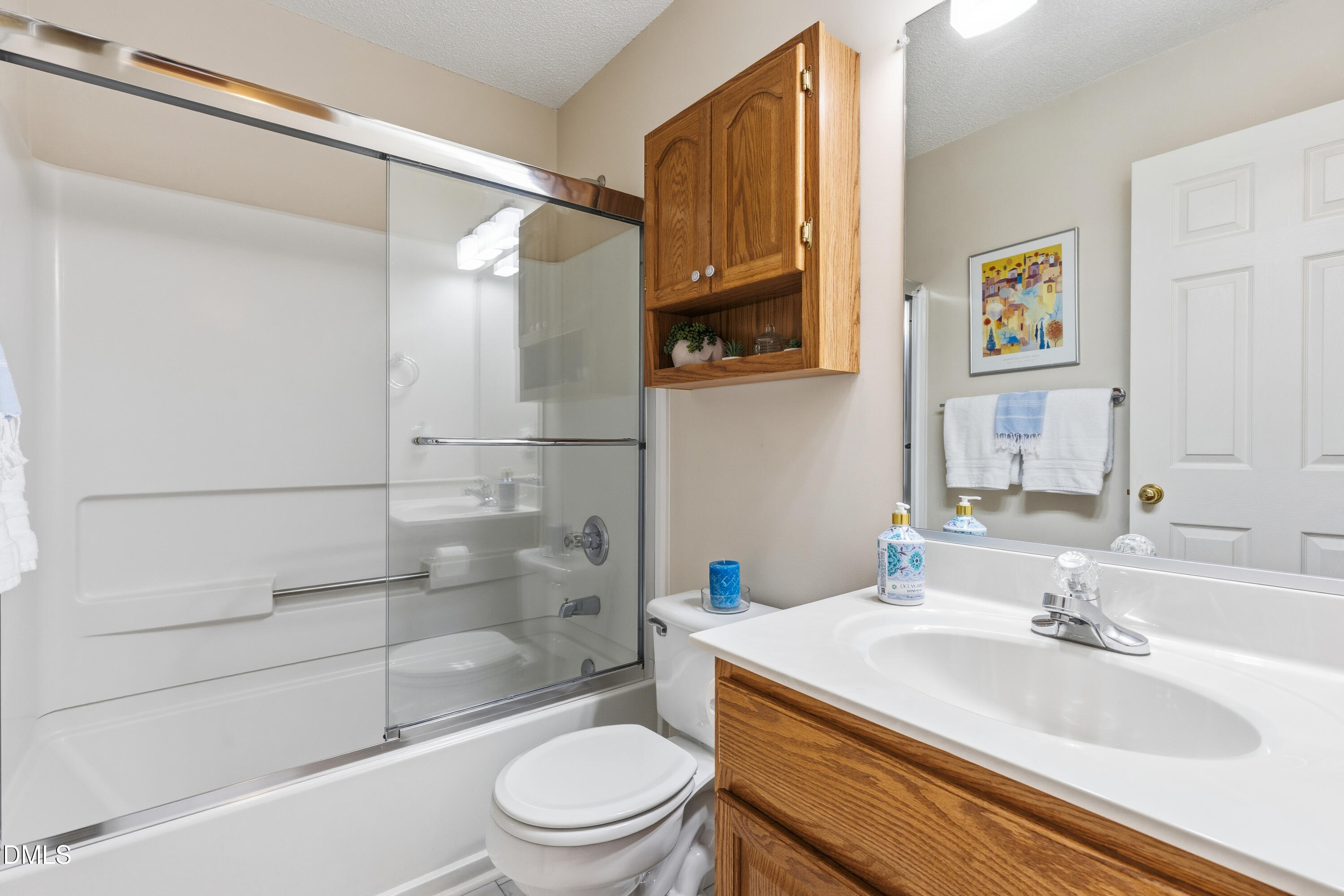 1211 Waterford Green Drive Apex, NC 27502 - Photo 41 of 53 a bathroom with a granite countertop sink toilet and shower