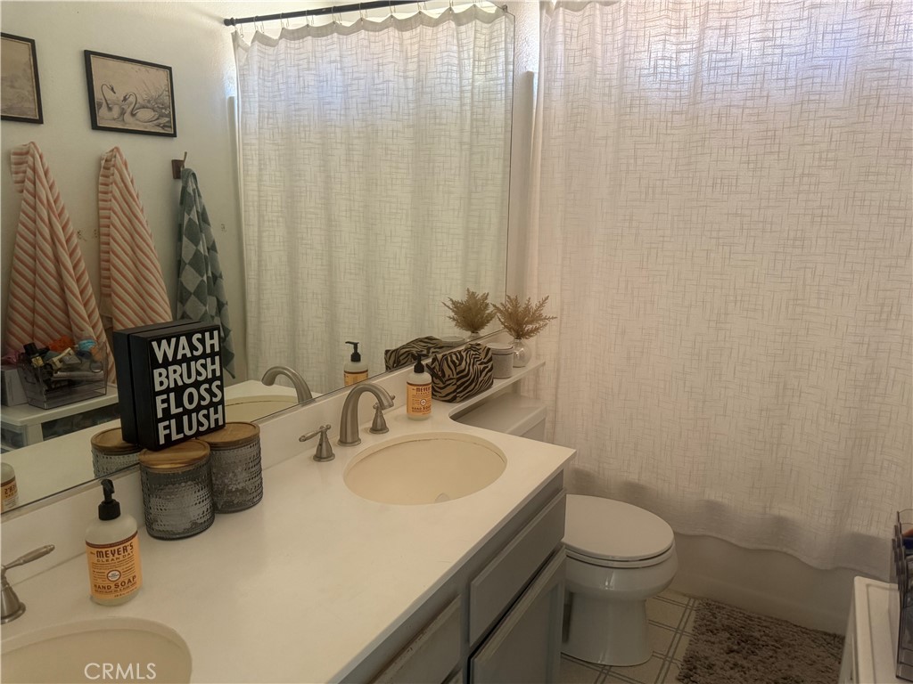 29870 Vail Brook Drive Temecula, CA 92591 - Photo 11 of 14 a bathroom with a sink toilet and shower