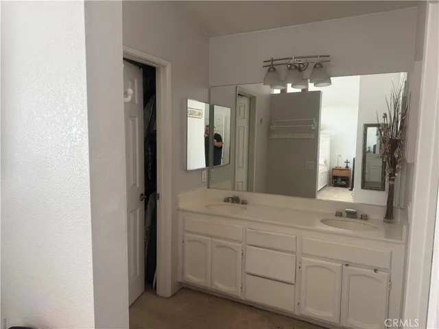 a bathroom with a double vanity sink and mirror