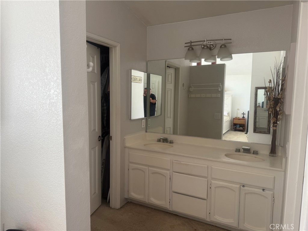 29870 Vail Brook Drive Temecula, CA 92591 - Photo 14 of 14 a bathroom with a double vanity sink and mirror