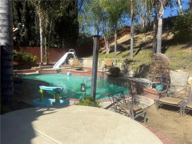 a view of a swimming pool with a patio