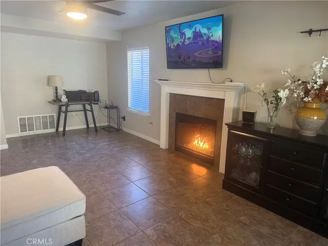 a living room with furniture a fireplace and wall paintings
