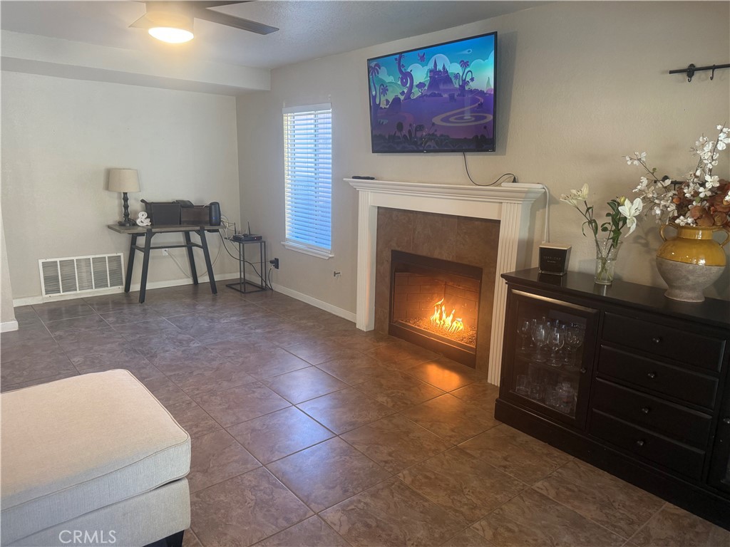 29870 Vail Brook Drive Temecula, CA 92591 - Photo 8 of 14 a living room with furniture a fireplace and wall paintings